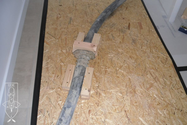 Screed pump pipe joints secured to floor protection to prevent pipe movement 